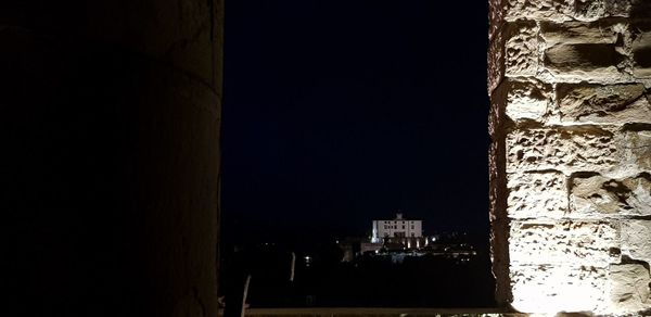 Illuminated building against sky at night