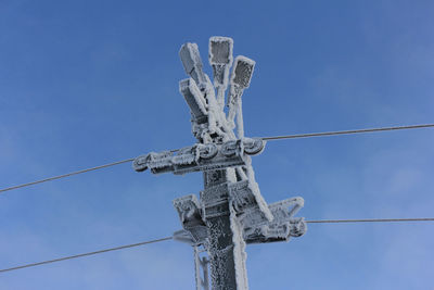 Low angle view of cross against clear blue sky