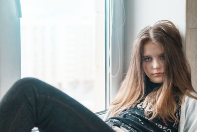 Portrait of girl with long hair relaxing at home