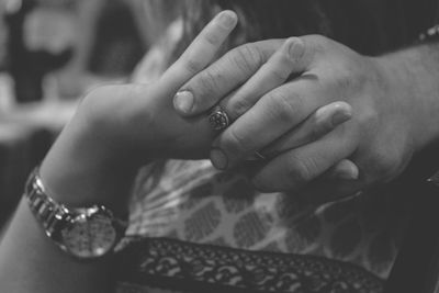 Close-up of couple holding hands