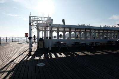 Rear view of man walking on railroad station platform