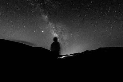 Silhouette man against sky at night