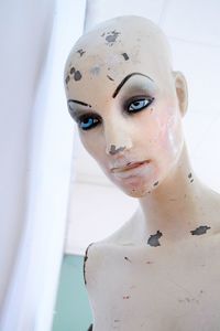 Close-up of weathered mannequin at store