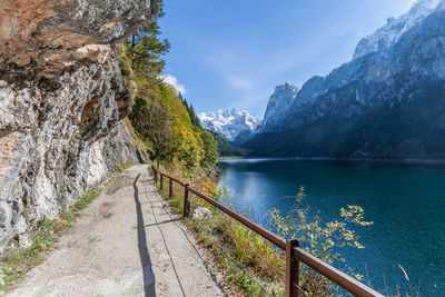 Scenic view of lake by mountains against sky