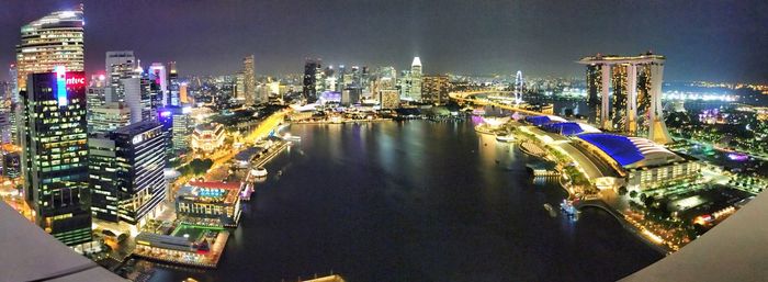 Illuminated cityscape against sky at night