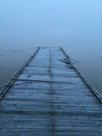 Old wooden pier disappearing in fog- no filters used