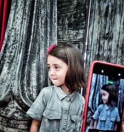 Portrait of young woman looking through window