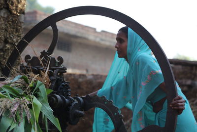 Woman using chaff cutter at farm