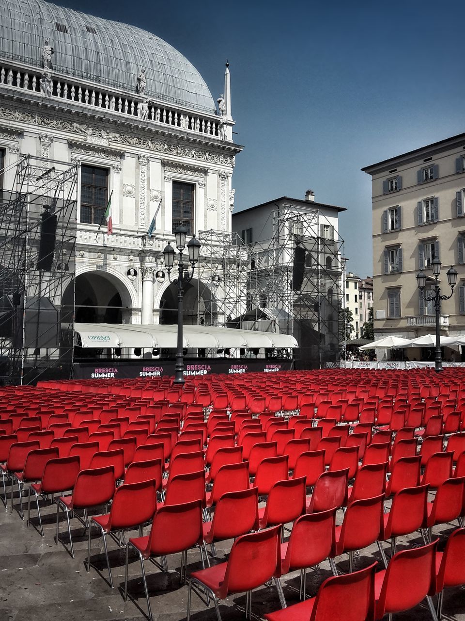 architecture, built structure, building exterior, red, chair, outdoors, day, travel destinations, clear sky, seat, no people, city, sky