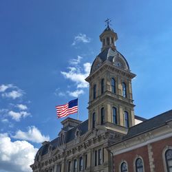 Low angle view of flag against blue sky