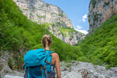 Rear view of woman walking on mountain