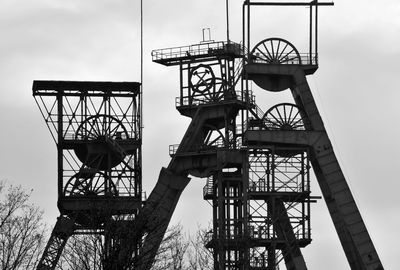 Low angle view of crane tower against sky