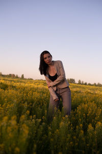 Young woman standing on field