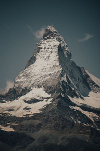 Low angle view of snowcapped mountain against sky
