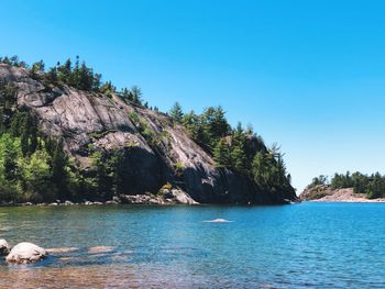 Scenic view of sea against clear blue sky