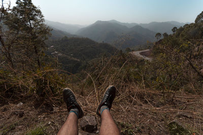 Low section of person relaxing on mountain