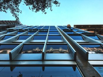 Low angle view of modern building against blue sky