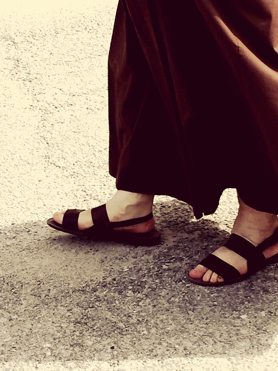 LOW SECTION OF WOMAN STANDING ON STREET IN CITY