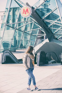 Full length of woman standing by railing