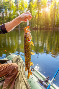 Man holding fish in lake