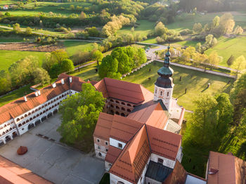 High angle view of houses amidst trees and buildings