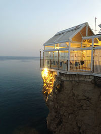 Scenic view of sea against clear sky at sunset