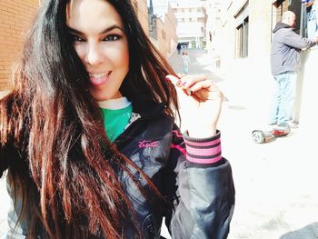 Portrait of smiling young woman in city