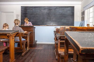 High angle view of people sitting on table