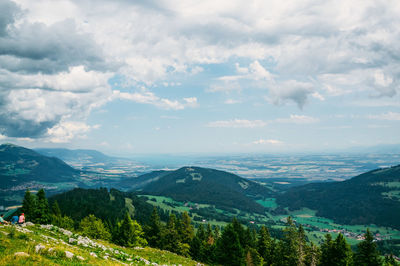 Scenic view of mountains against cloudy sky