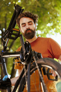 Portrait of young man riding bicycle