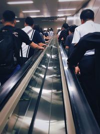 Low angle view of people on escalator