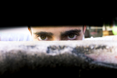 Close-up portrait of young man with hazel eyes