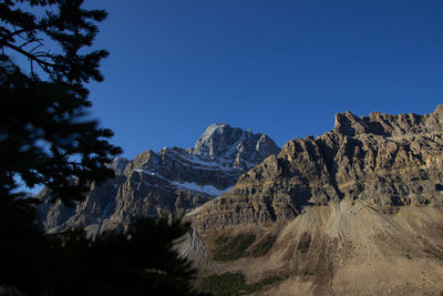 Scenic view of mountains against clear blue sky