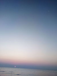 Scenic view of sea against clear sky at sunset