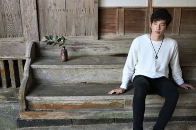 Portrait of young man sitting on chair