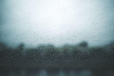 Full frame shot of wet glass window during rainy season