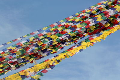 Low angle view of colorful buntings hanging against sky