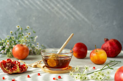 Honey, pomegranates and apples. rosh hashanah celebration and autumn harvesting concept.