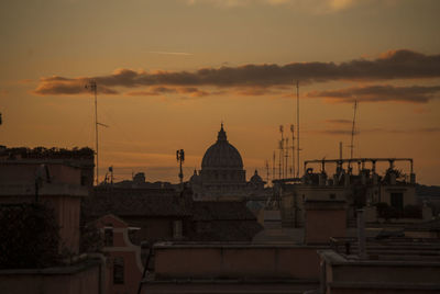 Built structures against sky during sunset