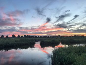 Scenic view of lake against sky during sunset