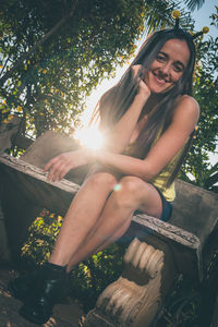 Portrait of smiling young woman sitting outdoors