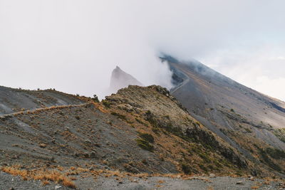 Mount meru partly covered by clouds, arusha national park, tanzania