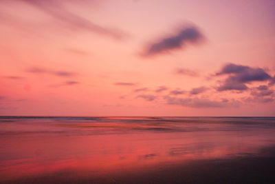 Scenic view of sea against orange sky