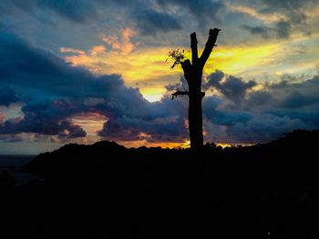 Silhouette of landscape against cloudy sky