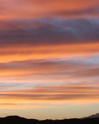 Scenic view of dramatic sky at sunset