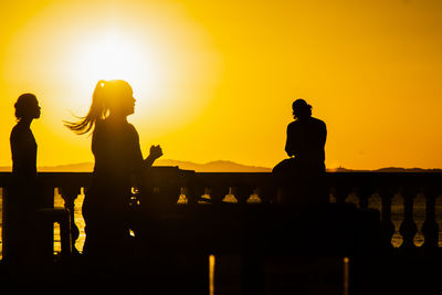 Silhouette people at sunset