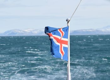Close-up of flag against sea