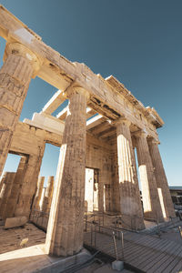 Low angle view of old ruins against clear blue sky