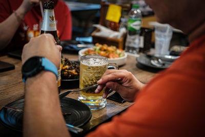 Cropped hand of woman holding drink