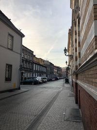 Street amidst buildings in city against sky